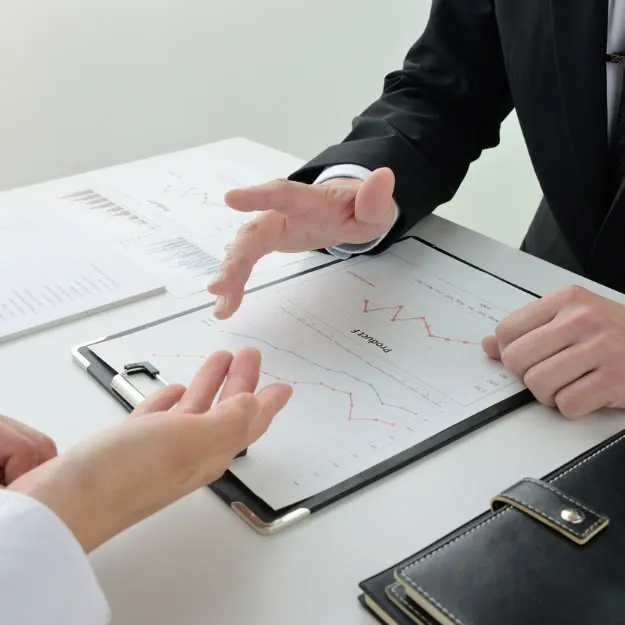 Two people reviewing a report at a desk