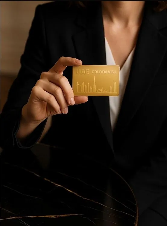 Business professional holding a UAE Golden Visa card